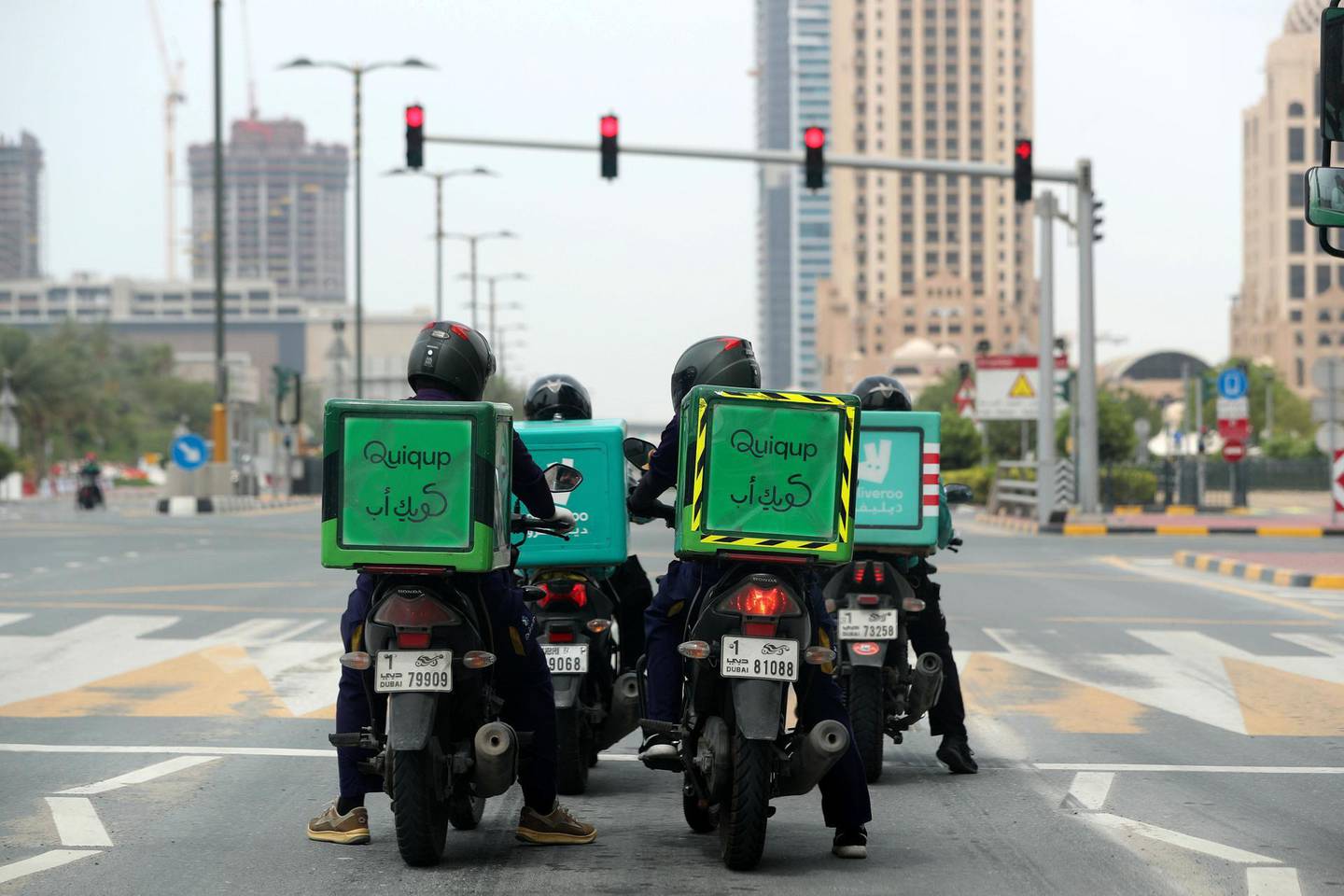 Dubai, United Arab Emirates - Reporter: N/A: Coronavirus. Delivery drivers wait at a red light during the 24hr lockdown due to Covid-19. Tuesday, April 14th, 2020. Dubai. Chris Whiteoak / The National