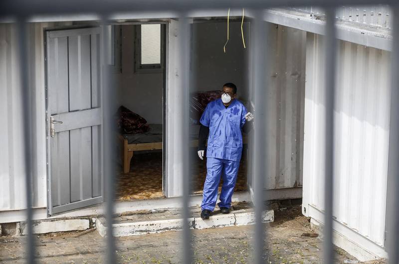 A health worker wearing protective masks stands at a quarantine zone installed by the Palestinian health ministry in the Gaza Strip to test incoming travellers at the Rafah border crossing with Egypt in the south of the Hamas-run enclave on February 16, 2020, amidst efforts against the novel coronavirus (COVID-19 acute respiratory disease) outbreak.  / AFP / SAID KHATIB
