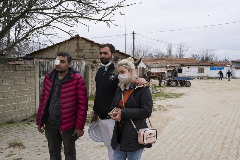 Refugees in Edirne, Turkey, near the border with Greece, wear protective face masks on March 10, 2020. Bloomberg