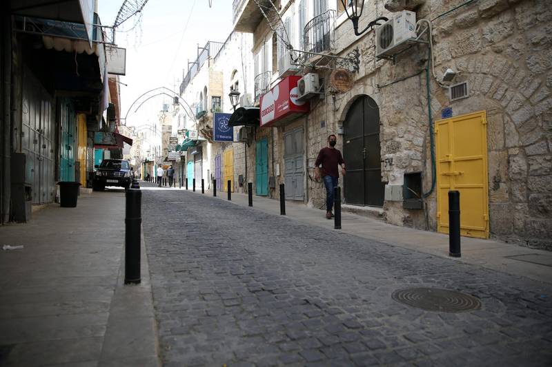 A man walks in an empty street in Bethlehem, West Bank. Bethlehem is one of the Palestinian cities, along with Qalqilya, Tulkarm, Nablus, Ramallah, Hebron, and Jenin, that were placed under full lockdown as part of the Palestinian authorities efforts to curb the spread of Covid-19.  EPA