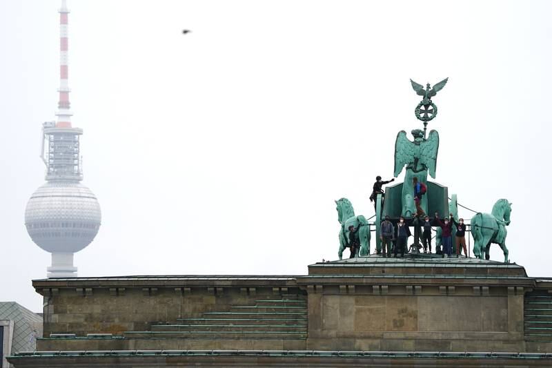Demonstrators stand on top of the Brandenburg Gate. EPA