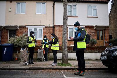 Volunteers prepare to deliver coronavirus test kits as part of surge testing for the South African variant of Covid-19, to residents in West Ealing, London. AFP
