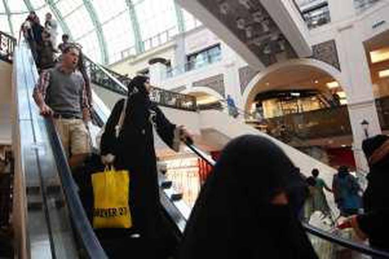 DUBAI, UNITED ARAB EMIRATES - DECEMBER 03:  Women ride an escalator in the huge shopping complex 'Mall of the Emirates' on December 3, 2009 in Dubai, United Arab Emirates. Stock markets in Dubai and Abu Dhabi fell sharply this week after state owned company Dubai World asked for more time to pay off debts amounting to £35 billion. The Dubai economy which has enjoyed years of rapid growth has seen a sharp decline recently as world markets reacted to the global economic crisis.  (Photo by Dan Kitwood/Getty Images) *** Local Caption ***  GYI0059058019.jpg