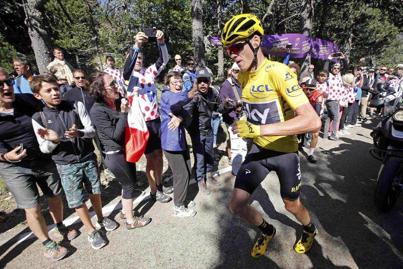 Yellow jersey leader Team Sky rider Chris Froome of Britain runs on the road after a fall. Jean-Paul Pelissier / Reuters