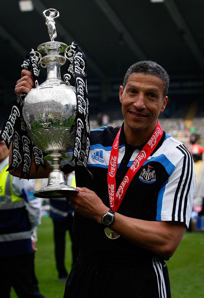 NEWCASTLE UPON TYNE, ENGLAND - APRIL 24:  Newcastle manager Chris Hughton lifts the trophy as Newcastle are crowned champions of the Championship after the Coca Cola Championship match between Newcastle United and  Ipswich Town at St. James Park on April 24, 2010 in Newcastle upon Tyne, England.  (Photo by Stu Forster/Getty Images)