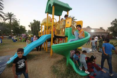 Iraqi children play in Baghdad's Zawraa Park after the government lifted coronavirus restrictions. AFP