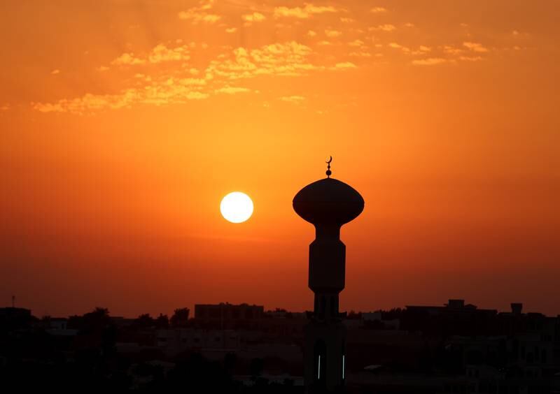 The sun sets over a mosque in Ras Al Khaimah. Chris Whiteoak / The National