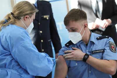 A German police officer receives a dose of AstraZeneca's vaccine in Mainz, Germany. Reuters