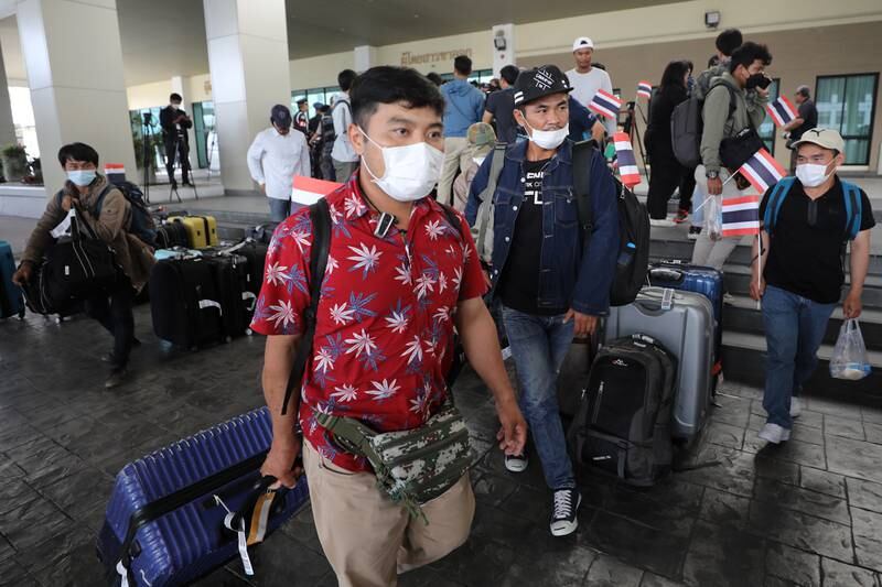 Thai migrant workers evacuated from Israel arrive at a military airport in Bangkok. EPA
