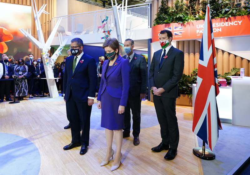 Cop26 President Alok Sharma and Scotland's First Minister Nicola Sturgeon observe a two-minute silence to remember the war dead on Armistice Day in the UK Pavilion at Cop26. PA