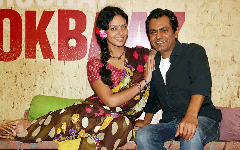 Indian Bengali actress Bidita Bag (L) and Bollywood actor Nawazuddin Siddiqui pose for a photograph during a promotional event for the forthcoming Hindi film 'Babumoshai Bandookbaaz' directed by Kushan Nandy in Mumbai on July 11, 2017. / AFP PHOTO / STR