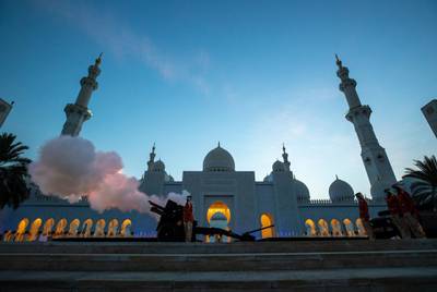 Abu Dhabi, United Arab Emirates, April 13, 2021.  A cannon is fired at Sheikh Zayed Grand Mosque, Abu Dhabi, to mark the beginning of iftar in 2021.  Victor Besa/The NationalSection:  NA