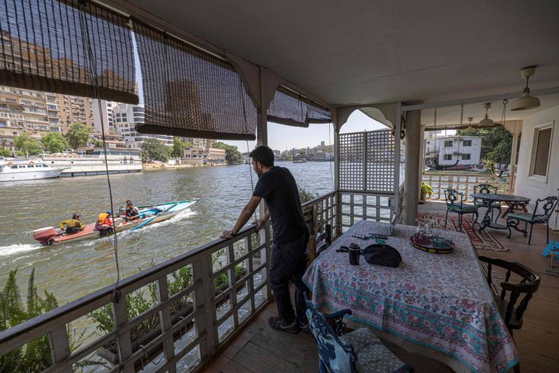 Egyptian-British citizen Omar Robert Hamilton, 37, on the balcony of his houseboat in the Agouza district on the Giza bank of the Nile on June 27, 2022. A campaign to save the houseboats has been launched online, with a petition garnering more than 4,000 signatures. AFP