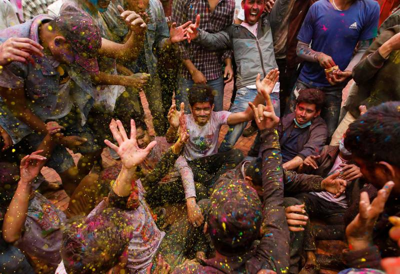 People throw coloured powder at each other as they gather to celebrate Holi, the festival of colours, in Kathmandu, Nepal. Reuters