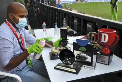 The trophys and prizes being sanitized by IMG staff before being given away to the winners, during match 44 of season 13 of the Dream 11 Indian Premier League (IPL) between the Royal Challengers Bangalore and the Chennai Super Kings held at the Dubai International Cricket Stadium, Dubai in the United Arab Emirates on the 25th October 2020.  Photo by: Samuel Rajkumar  / Sportzpics for BCCI