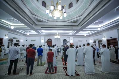 Worshippers at Ibn Taymiyyah Mosque in Abu Dhabi gather for evening prayers on the day the death of President Sheikh Khalifa was announced. Victor Besa / The National.