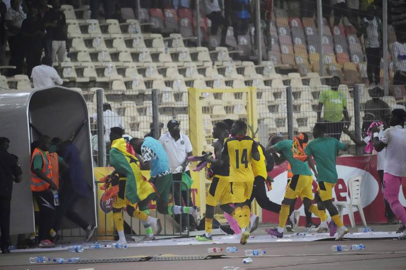 Ghana players run down the tunnel following a pitch invasion after the match. AP