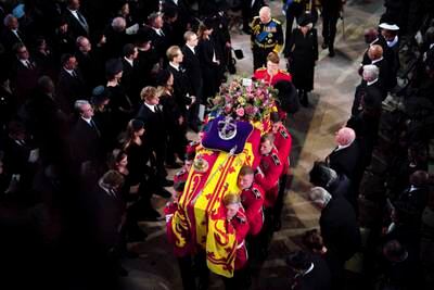 King Charles and the Queen Consort Camilla follow the coffin at St George's Chapel. AP