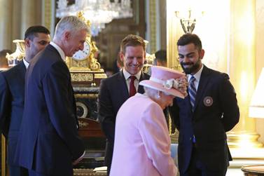 Virat Kohli, right, with Eoin Morgan, the England captain centre, meets Queen Elizabeth II at Buckingham Palace. AFP