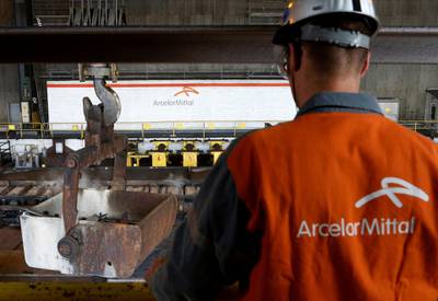FILE PHOTO: A worker surveys the production process at the ArcelorMittal steel plant in Ghent, Belgium, July 7, 2016. REUTERS/Francois Lenoir - D1BETPDXORAA/File Photo