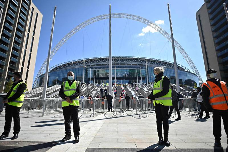 Workers wait to admit fans to Wembley Stadium to watch the English League Cup final football match between Manchester City and Tottenham Hotspur, in northwest London. AFP