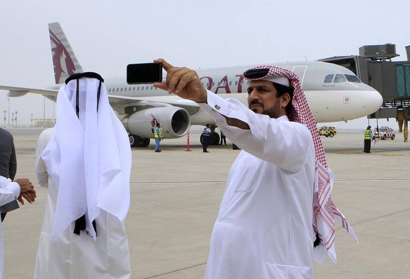 Qataris take pictures after the first flight chartered by Qatar Airways landed at Doha’s new Hamad International Airport. Karim Jaafar / AFP