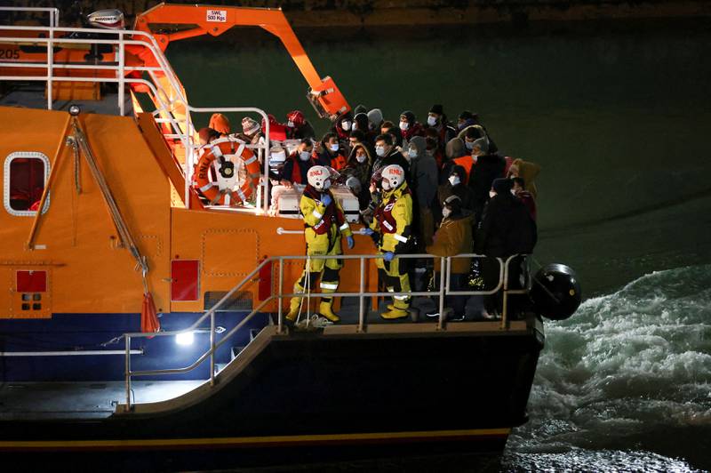 Migrants arrive at Dover on a Royal National Lifeboat Institution vessel, after being rescued while crossing the English Channel. Despite it being midwinter, migrant crossings resumed this week after a period of bad weather led to a pause. Reuters