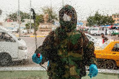 A civil defence worker disinfects a window in the Ashar district of Iraq's southern city of Basra.   AFP