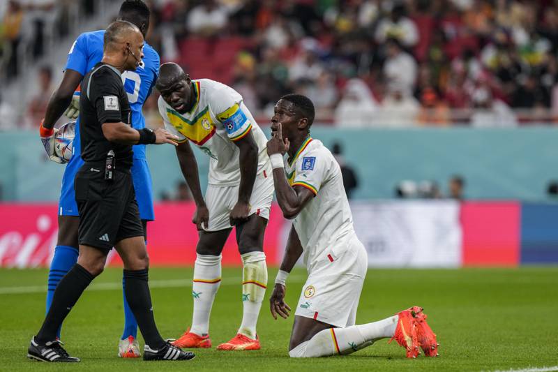 Senegal's Pape Abou Cisse, right, remonstrates with referee Wilton Sampaio. AP 