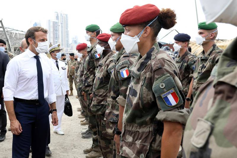 French President Emmanuel Macron meets members of the military mobilised for the reconstruction of the port of Beirut, in Beirut, Lebanon. Reuters