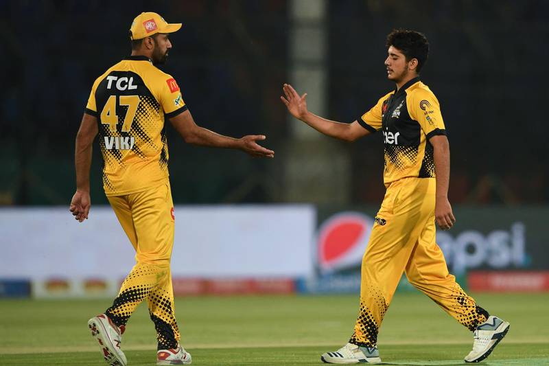 Peshawar Zalmi' Mohammad Amir, right, celebrates with captain Wahab Riaz after the dismissal of Multan Sultans' Ravi Bopara. AFP