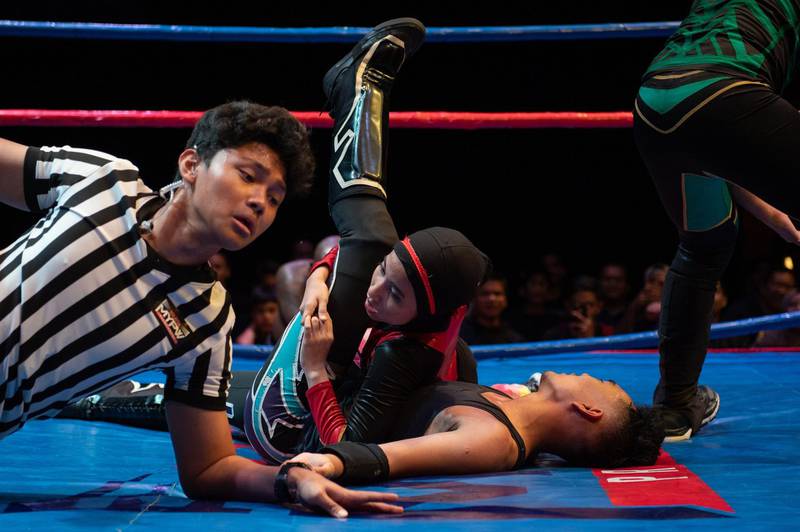 Nor "Phoenix" Diana pins a male opponent during a match organised by Malaysia Pro Wrestling in Kuala Lumpur.