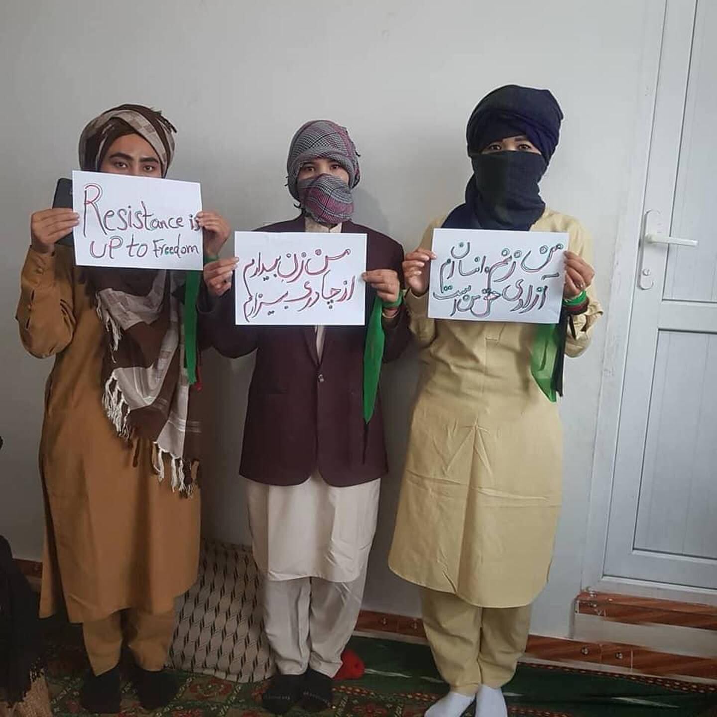 Afghan women pose for a photo in men's clothing in a form of protest started by Rabia Balkhi to oppose restrictions imposed on women by Afghanistan's Taliban rulers.