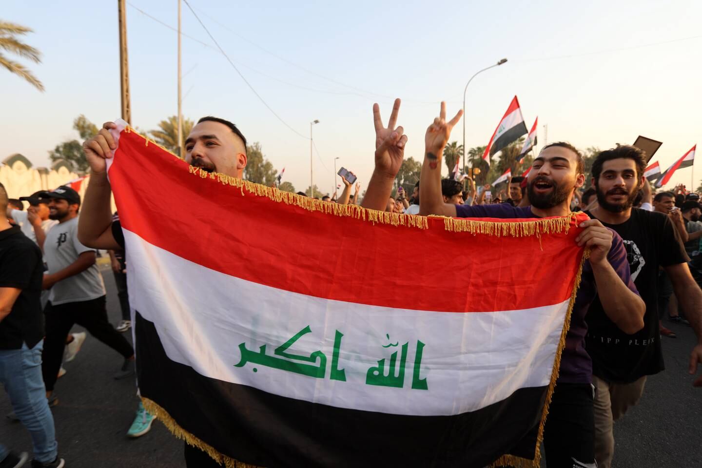 Iraqi protesters chant anti-government slogans and carry the Iraqi national flag during a protest near the Supreme Judicial Council building in central Baghdad, Iraq, on September 2. EPA