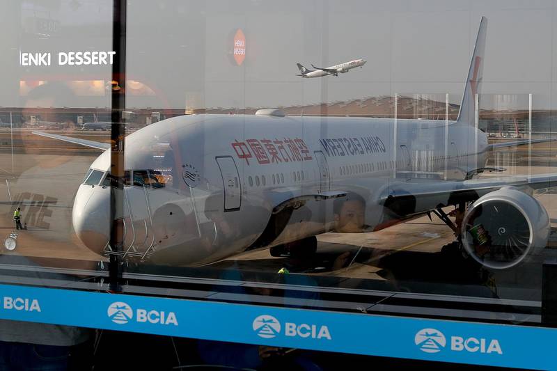 FILE - This Nov. 19, 2016, file photo shows China Eastern Airlines' Boeing 777 passenger airplane through window glasses at the Beijing Capital International Airport in Beijing. Taiwan refused to allow two Chinese airlines, China Eastern Airlines and Xiamen Airlines, to expand service to the island during the Lunar New Year holiday, a news agency reported Monday, Jan. 29, 2018, after Beijing angered Taiwanâ€™s government by approving new air routes. (AP Photo/Andy Wong, File)