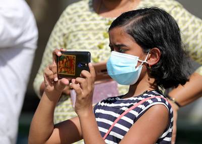 Dubai, United Arab Emirates - Reporter: N/A. News. Coronavirus/Covid-19. A young girl films a presentation while wearing a mask. Wednesday, October 14th, 2020. The Sevens, Dubai. Chris Whiteoak / The National