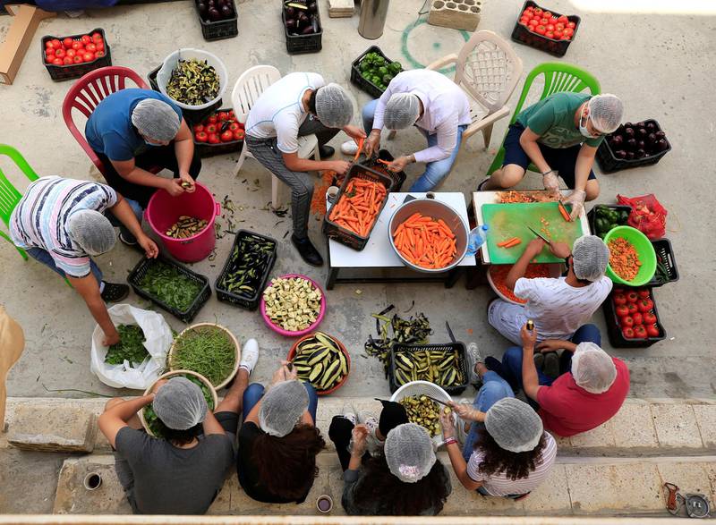Volunteers prepare food for distribution to people in need in the port city of Sidon, Lebanon. Reuters