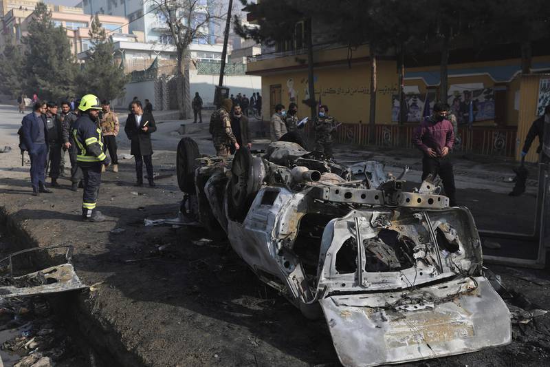 Afghan security officers inspect the site of a bombing attack in Kabul on January 10, 2021. AP Photo