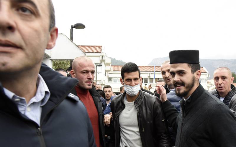 Novak Djokovic, center, arrives in a municipal building in Budva, Montenegro. AP