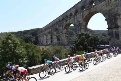 France's Julian Alaphilippe, wearing the overall leader's yellow jersey, crosses the Pont du Gard during the 16th stage on July 23, 2019.  AFP
