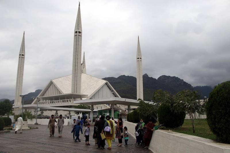 People visit the Faisal Mosque in Islamabad, Pakistan, despite government restrictions imposed after new cases of the coronavirus were reported across the country. EPA