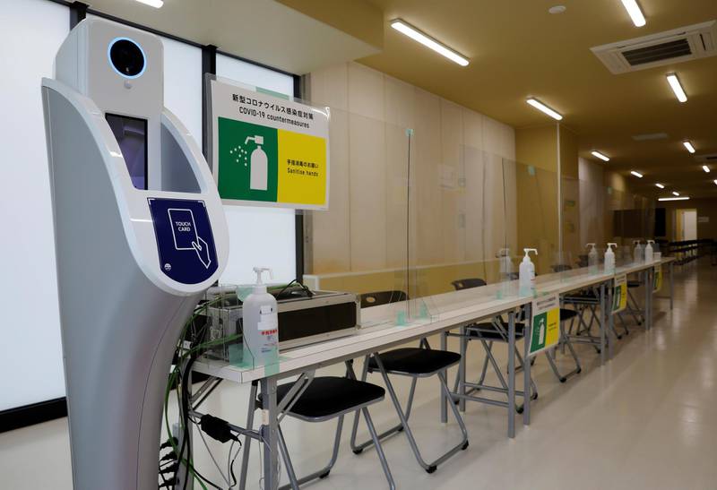 A machine to check body temperature and hand sanitizers are placed at the doping control station.