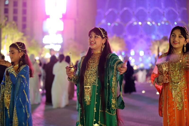 Emirati girls welcome guests before the Expo 2020 Dubai opening ceremony. Chris Whiteoak / The National
