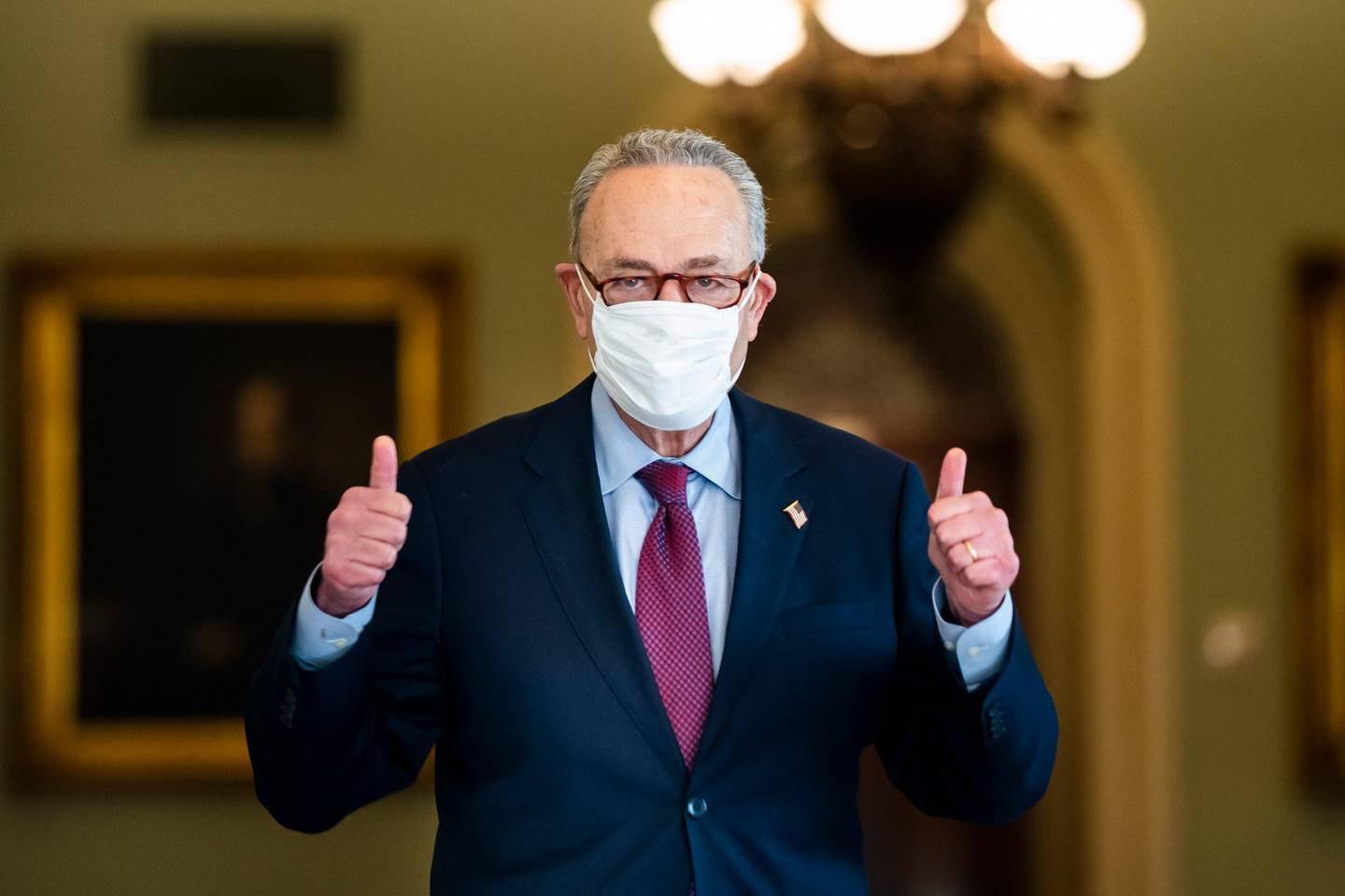 epa09057280 Democratic Senate Majority Leader Chuck Schumer gives a thumbs-up after the Senate voted to approve President Biden's Covid relief package in the US Capitol in Washington, DC, USA, 06 March 2021.  EPA/JIM LO SCALZO