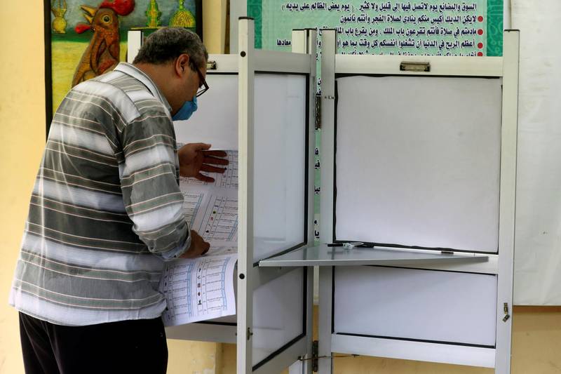 A voter fills out his ballot at a school in Cairo. REUTERS