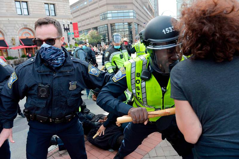 Counter protesters and police clash outside of a gathering of the far right group 'Super Fun Happy America' as they hold a protest in Copley Square in Boston, Massachusetts.   AFP