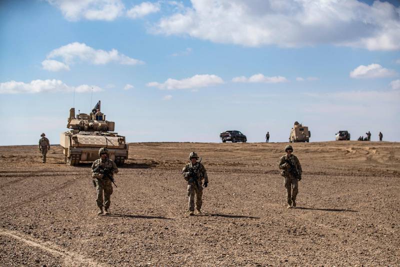 SDF troops and the US-led anti-ISIS coalition take part in military exercises in Syria's Deir Ezzor province in March 2022. AFP