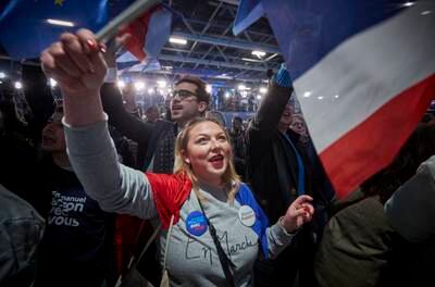 Supporters cheer in Paris as exit polls indicated Mr Macron would win the election. Getty Images