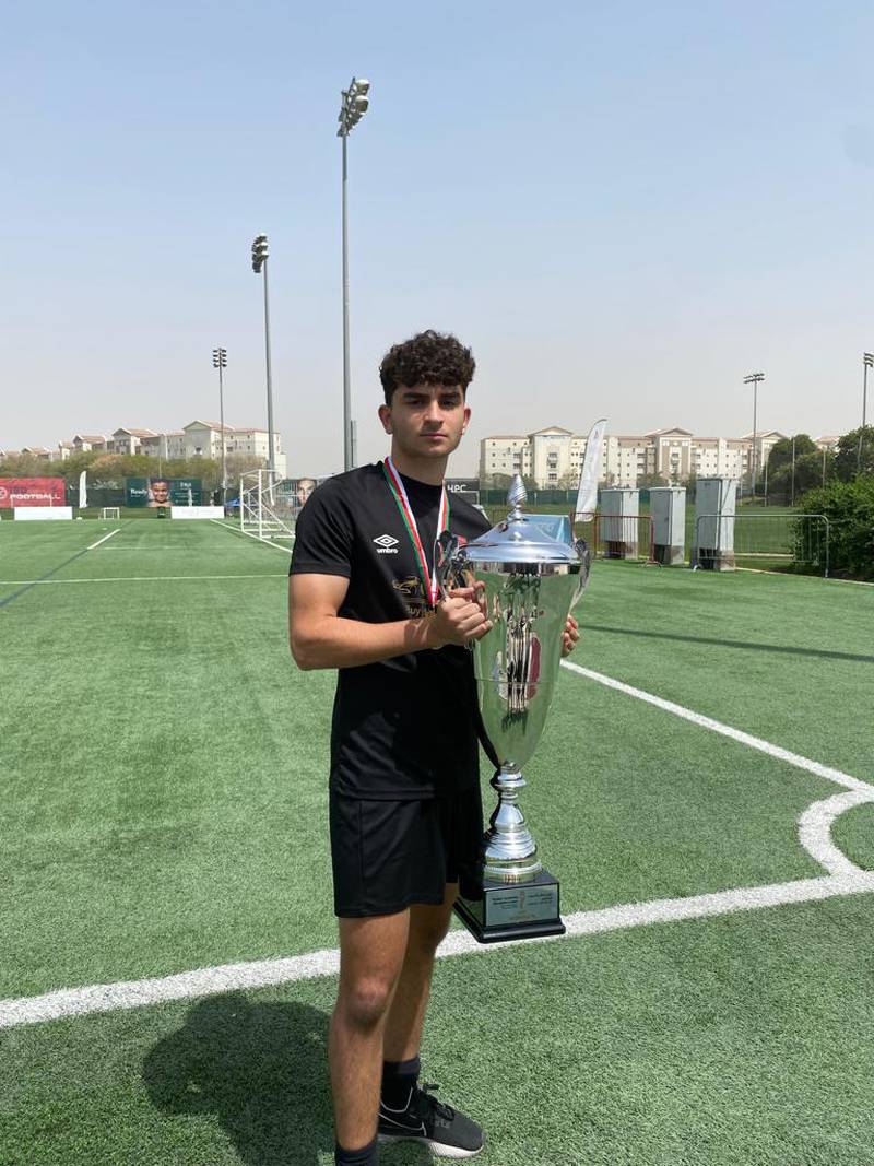 Ahmad, who is a defender for The Football Academy team in Dubai, displays the Youth Football League - Dubai champions trophy. Photo: Supplied