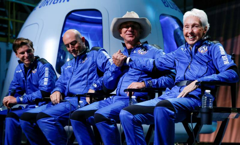 Billionaire businessman Jeff Bezos shakes hands with Wally Funk, who became the oldest person in space with other crew mates Oliver Daemen (left) and Mark Bezos (second from left). Reuters
